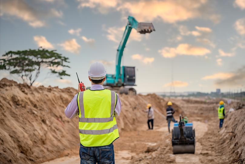 An excavator clearing land for a construction project