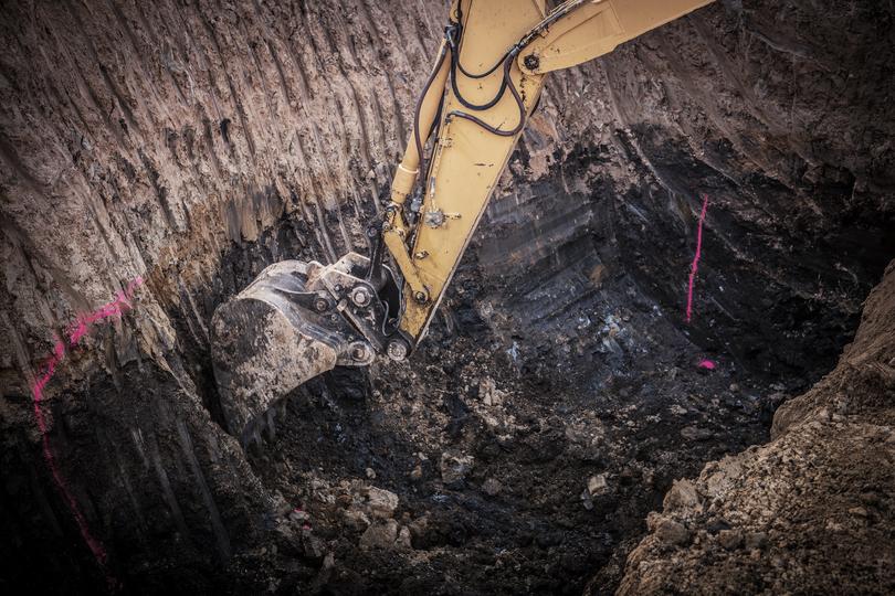 An excavator clearing land for a construction project