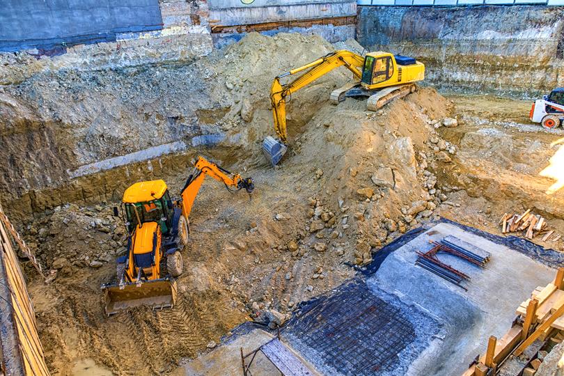 An excavator clearing land for a construction project