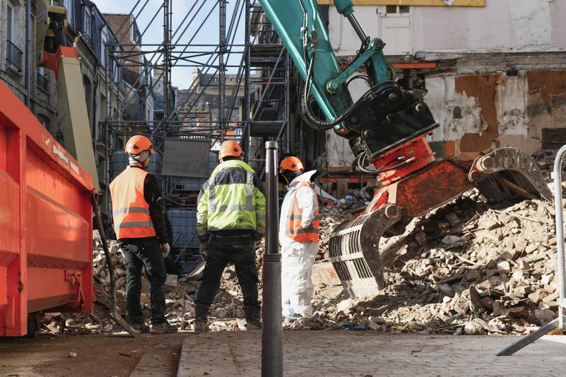 A demolition crew safely dismantling a building